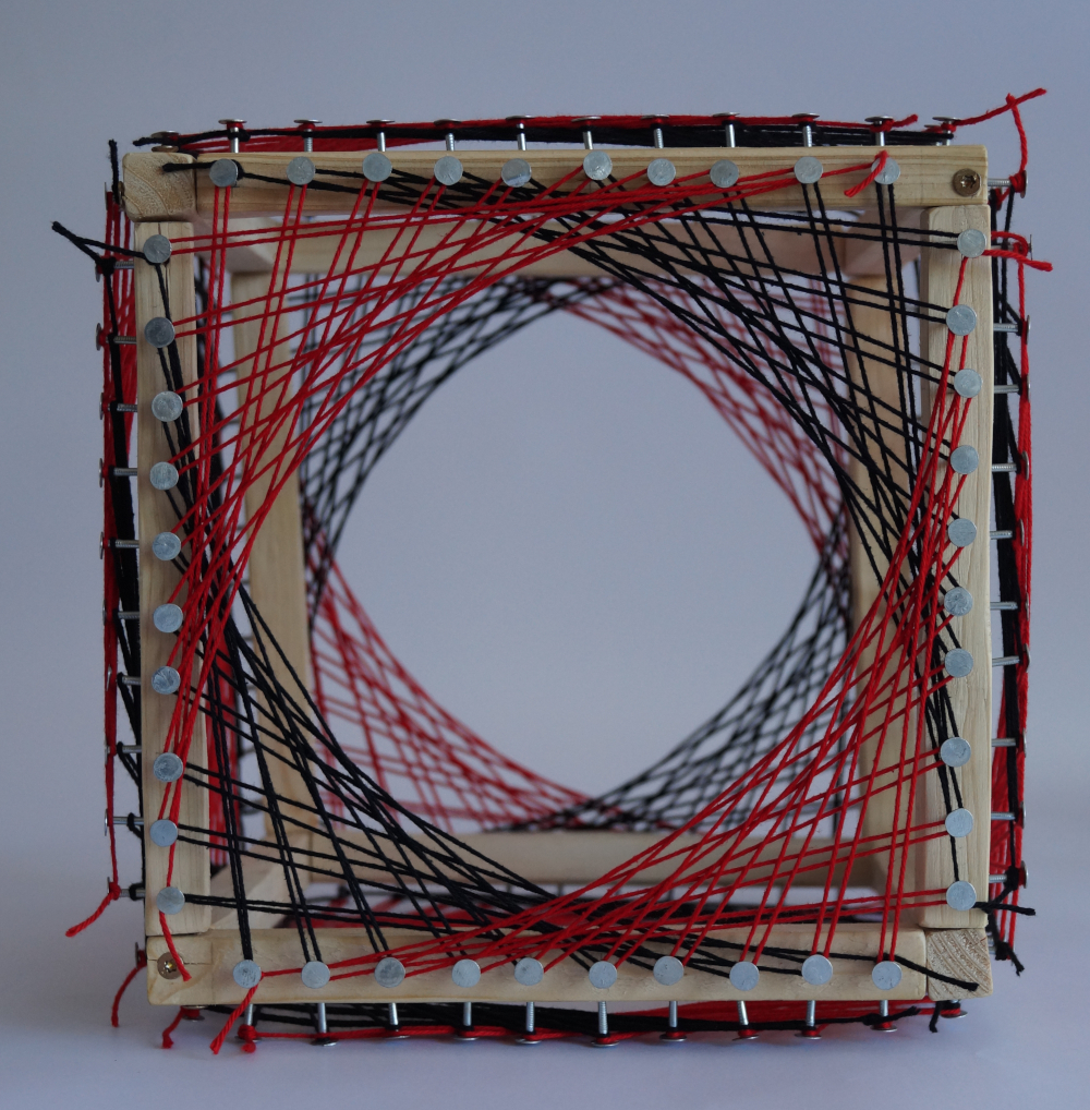 A cube made from wood, with hollow sides. Along the edges of the cube, nails are added. These are connected across the faces of the cube by strings.